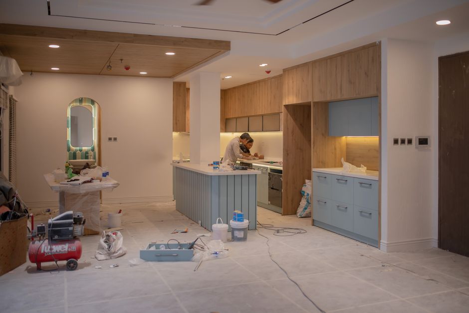 Contractor carefully installing custom kitchen cabinets